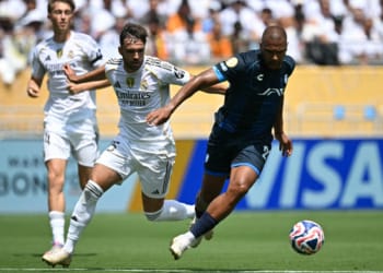 Real Madrid's Spanish defender #35 Raul Asencio (L) fights for the ball with Pachuca's Venezuelan forward #23 Salomon Rondon during the FIFA Club World Cup 2025 Group H football match between Spain's Real Madrid and Mexico's Pachuca at the Bank of America stadium in Charlotte on June 22, 2025. (Photo by Paul ELLIS / AFP)